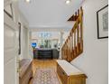 Bright foyer with hardwood floors, staircase, and a glimpse into the living area at 1009 Seacrest Ln, Folly Beach, SC 29439