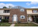 Charming townhome featuring a brick facade and a well-lit front entrance, perfect for a cozy neighborhood feel at 102 Brush Blvd, Goose Creek, SC 29445