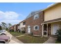 A neighborhood view of the townhomes along a sidewalk, with cars parked nearby offering easy access at 102 Brush Blvd, Goose Creek, SC 29445