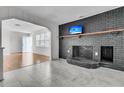 Cozy living room featuring a painted brick fireplace, mantle, and television above at 105 Gourdin St, Saint Stephen, SC 29479