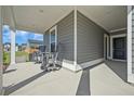 Inviting covered front porch with seating, offering a relaxing outdoor space with lovely views at 107 Cotton Blossom Way, Summerville, SC 29485