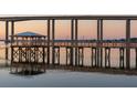 Picturesque pier with gazebo offering stunning waterfront views under a bridge at 108 Fairbanks Oak Aly # 302, Daniel Island, SC 29492