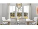 Elegant dining room featuring a modern chandelier and large windows offering lots of natural light at 1441 Clay Field Trl, Summerville, SC 29485