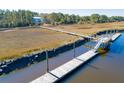 Aerial view of private dock featuring access to marsh, perfect for fishing, boating, and enjoying scenic views at 1602 John Fenwick Ln, Johns Island, SC 29455