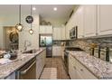 A sleek kitchen featuring granite counters, mosaic backsplash, and modern fixtures at 170 Collared Dove Ct, Summerville, SC 29483