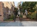 Landscaped courtyard with wrought iron gates leading to the building entrance at 182 E Bay St # 303, Charleston, SC 29401
