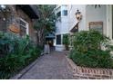 Brick walkway leading to the building entrance, adorned with lush greenery at 182 E Bay St # 303, Charleston, SC 29401