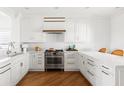 Bright kitchen with custom cabinets, marble countertops, stainless steel appliances, and hardwood floors at 19 Grand Pavilion Blvd, Isle of Palms, SC 29451