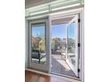A clear view onto the balcony through the glass paned doors provides a view of the street at 21 George St # 206, Charleston, SC 29401