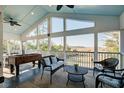 Screened-in porch with comfortable seating and foosball table, offering a serene outdoor living space at 2101 Guerins Bridge Rd, Wando, SC 29492