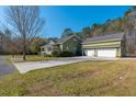 Spacious home with a three-car garage, well-manicured lawn, and paved driveway, offering ample parking at 2101 Heavens Way, Summerville, SC 29483