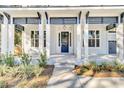 Inviting front entrance with white columns, blue accents, and neat landscaping and a dark blue door at 2210 Norwood Oaks Dr, Mount Pleasant, SC 29466