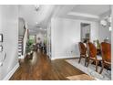 Inviting foyer with hardwood floors leading to a dining area and living space with a staircase and views of the backyard at 242 Bering Ln, Summerville, SC 29486