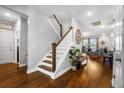 Bright foyer with hardwood floors, showcasing a staircase and a glimpse into the welcoming living area at 242 Bering Ln, Summerville, SC 29486