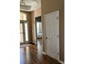 View of the entryway with hardwood floors, a decorative light fixture, and an open view of the bedroom at 2598 Spivey Ct, North Charleston, SC 29406