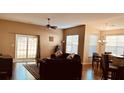 Inviting living room with sliding glass doors, hardwood floors, and adjacent dining area at 2598 Spivey Ct, North Charleston, SC 29406