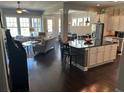 Open-concept living room with hardwood floors adjacent to kitchen island at 3668 Maidstone Dr, Mount Pleasant, SC 29466