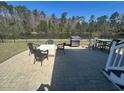 Paver patio features outdoor dining, grilling, and peaceful water views at 3668 Maidstone Dr, Mount Pleasant, SC 29466