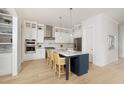 Modern kitchen with stainless steel appliances, a large island, and hardwood floors at 377 Blowing Fresh Dr, Charleston, SC 29492