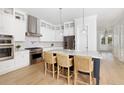 Elegant kitchen featuring an island with seating, stainless steel appliances, and custom cabinetry at 377 Blowing Fresh Dr, Charleston, SC 29492