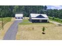 Inviting exterior view of home with a long driveway leading to a detached two-car garage at 407 Sandridge Acres Trl, Holly Hill, SC 29059