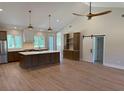 Bright, open-concept kitchen with a large island, stainless appliances, and vaulted ceilings at 407 Sandridge Acres Trl, Holly Hill, SC 29059