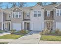 Well-manicured lawns and neutral siding enhances the townhome's curb appeal and charm at 4678 Palm View Cir, North Charleston, SC 29418