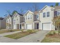 Inviting townhomes feature attached garages, manicured lawns, and classic siding for a welcoming exterior at 4678 Palm View Cir, North Charleston, SC 29418