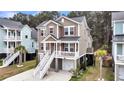 Beautiful elevated home featuring a spacious driveway, and manicured landscaping at 524 Amalie Farms Dr, Charleston, SC 29492