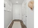 Bright, neutrally decorated hallway with wood floors, a hat, and framed art at 5567 Ruby Falls Drive Ln, North Charleston, SC 29420