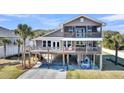 Charming elevated beach house featuring multiple decks, screened porch, and ground-level outdoor space at 601 Pompano Rd, Edisto Island, SC 29438