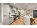 Well-lit kitchen featuring modern cabinets, stainless steel appliances, and a stylish breakfast bar at 7 Logan St # F, Charleston, SC 29401