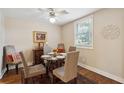 Inviting dining area with a glass table, upholstered chairs, and a decorative ceiling fan at 728 N Godfrey Park Pl, Charleston, SC 29407