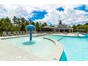 Community pool area featuring a playful water fountain, seating and a covered pavilion at 746 Meadowbrook Lane, Summerville, SC 29486