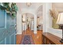 Welcoming foyer with hardwood floors and decorative accents, seamlessly connecting to the living spaces at 7503 Hawks Cir, Hanahan, SC 29410