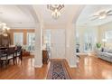 Spacious open-concept foyer with elegant lighting, hardwood floors, and seamless access to living and dining areas at 7503 Hawks Cir, Hanahan, SC 29410