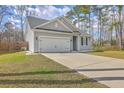 Single-story home features gray siding, attached garage, and a well-maintained front lawn at 94 Dean Dr, Summerville, SC 29483
