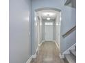 Inviting hallway with wood floors, neutral paint, and arched doorways creating a seamless transition at 94 Dean Dr, Summerville, SC 29483