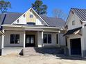 Charming new construction home featuring a covered entryway and yellow and white siding accents at 3945 Bulow Landing Rd, Hollywood, SC 29470