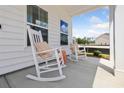 Relaxing front porch features a sitting area with rocking chairs and bright sunlight at 102 Snow St, Summerville, SC 29486
