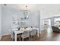 Dining room with a chandelier, table set for six, and views of the adjacent living spaces at 1049 Tea Time Dr, Summerville, SC 29485