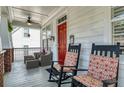 Charming front porch with rocking chairs, comfortable seating, and a bright red door at 109 White Pine Way, Summerville, SC 29485