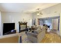 Bright living room features a fireplace, neutral walls, ceiling fan, and hardwood floors at 114 Tennyson Way, Summerville, SC 29486