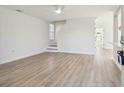 Light-filled living room with wood floors and staircase at 1412 Sandstone Pl, Charleston, SC 29492