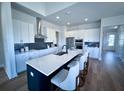 Modern kitchen features a large island with seating, stainless steel appliances, and a stylish backsplash at 1601 Trailmore Ln, Summerville, SC 29486