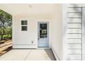 Charming home entryway with a blue door and ample natural light from the side window at 1630 Balsam St, Charleston, SC 29407