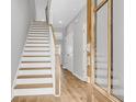 Bright hallway featuring wood floors, stairs, and access to the home's other rooms at 171 Cantona Dr, Summerville, SC 29483