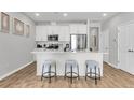 Open-concept kitchen with white cabinets, stainless steel appliances, and a breakfast bar with seating at 171 Cantona Dr, Summerville, SC 29483