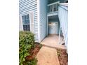 Entrance to condo with a storm door, a small porch and walkway and a well-maintained front lawn at 2011 Coldspring Dr # B, North Charleston, SC 29406