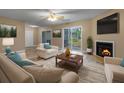Inviting living room with a fireplace, neutral furniture, and a sliding door leading to outdoor scenery at 2011 Coldspring Dr # B, North Charleston, SC 29406